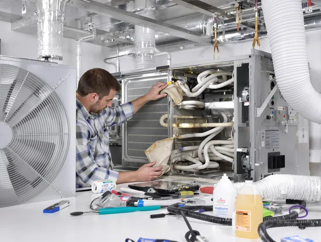 Bedford Air Duct Cleaning specialist performing precision AC coil cleaning in Bedford