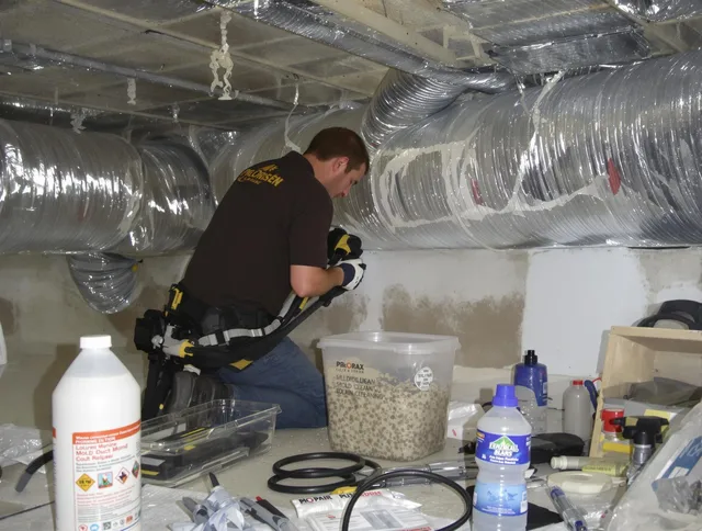 Bedford Air Duct Cleaning specialist performing professional mold removal from air ducts in Bedford