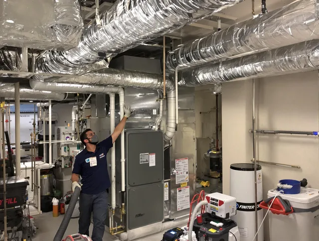 Bedford Air Duct Cleaning specialist performing thorough furnace duct cleaning in a Bedford residence