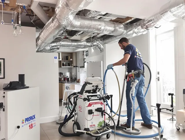 Bedford Air Duct Cleaning technician performing advanced pure duct cleaning with specialized equipment in Bedford