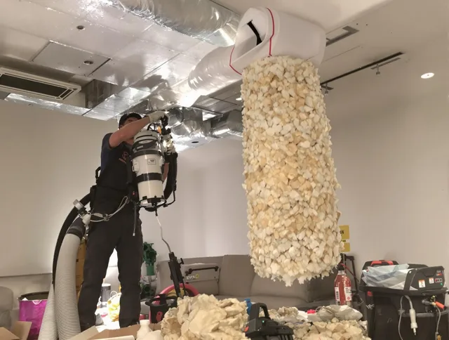 Bedford Air Duct Cleaning technician performing precision vacuum insulation removal in a residential property in Bedford