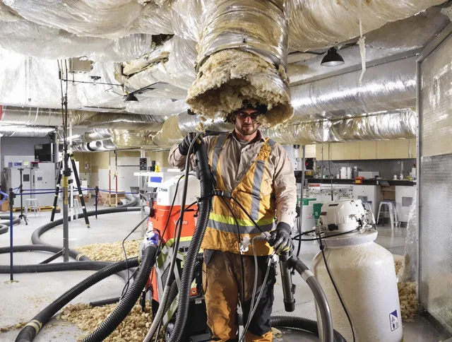 Professional vacuum insulation removal by Bedford Air Duct Cleaning expert in Bedford